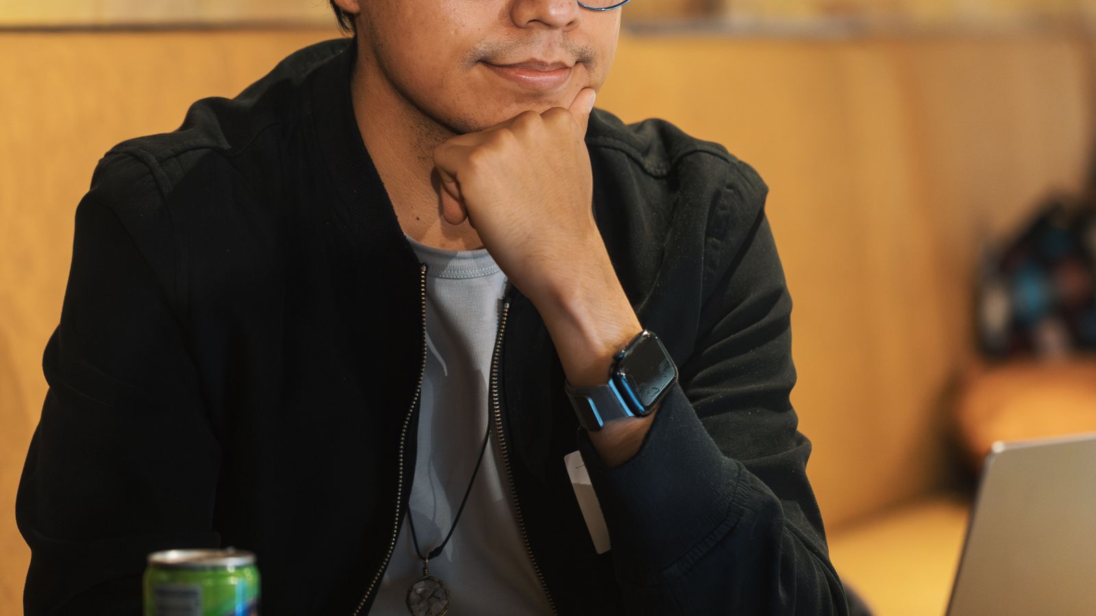 Person using a laptop in a shared cafe workspace